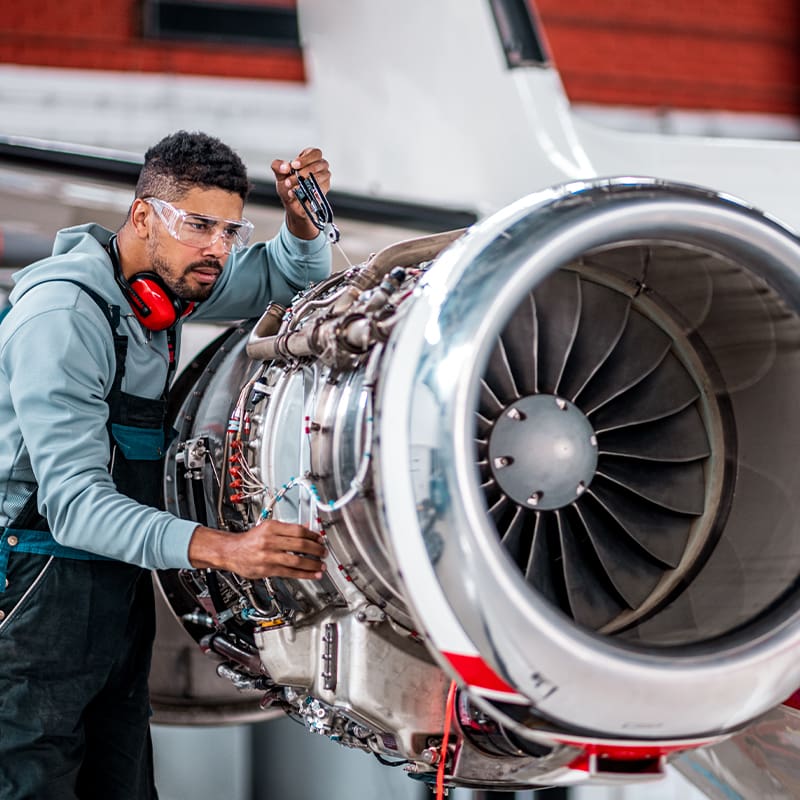 a man standing next to a car engine