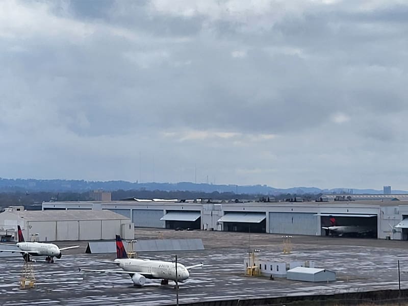a plane parked on the tarmac at an airport