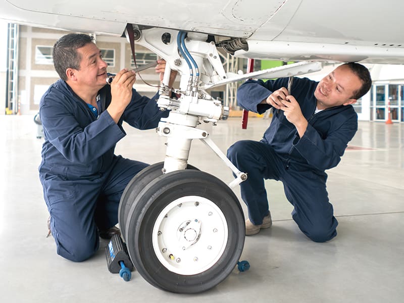 a man sitting in front of a plane