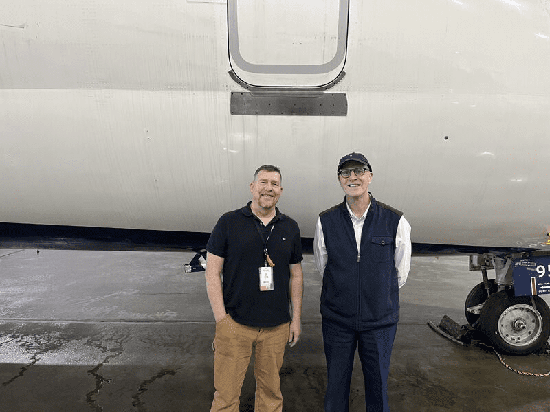 a man standing in front of a plane